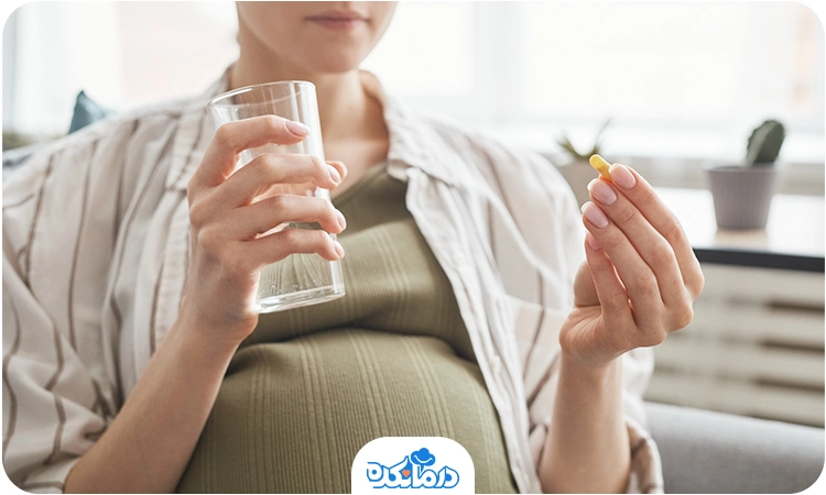 تصویر خانم بارداری در حال خوردن قرص فولیک اسید در بارداری هست